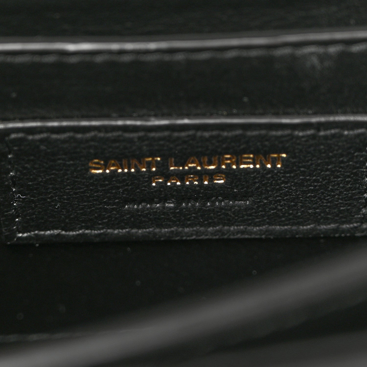 Black leather label reading SAINT LAURENT PARIS on inner lining.