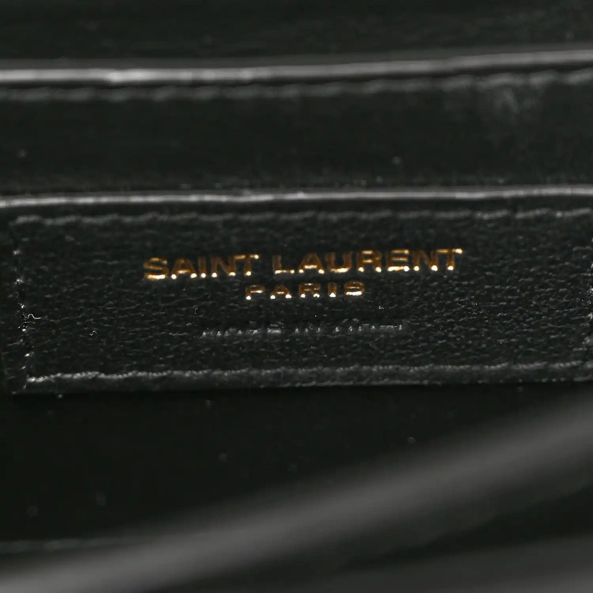 Black leather label reading SAINT LAURENT PARIS on inner lining.