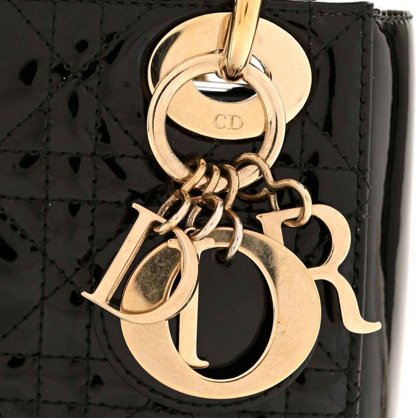 Black patent mini handbag with gold CD charm and chain hardware