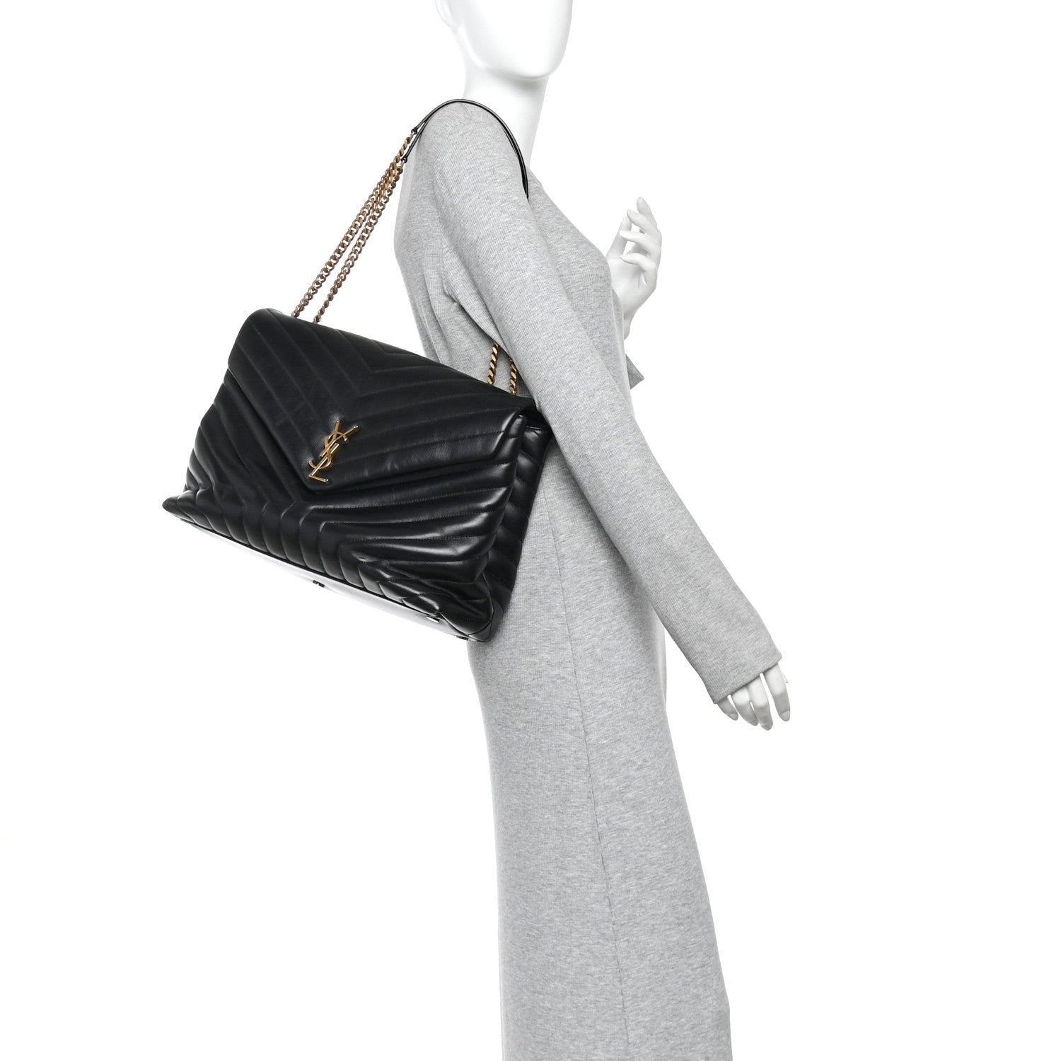 Black quilted calfskin satchel with gold chain strap, worn crossbody