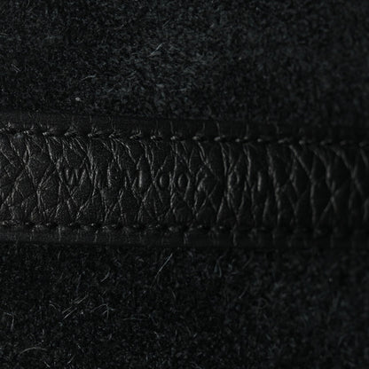 Black pebbled leather close-up of stitched edge