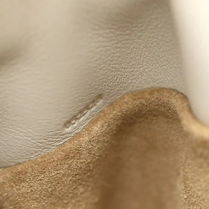 Pebbled leather lining with stitched seam near clutch opening