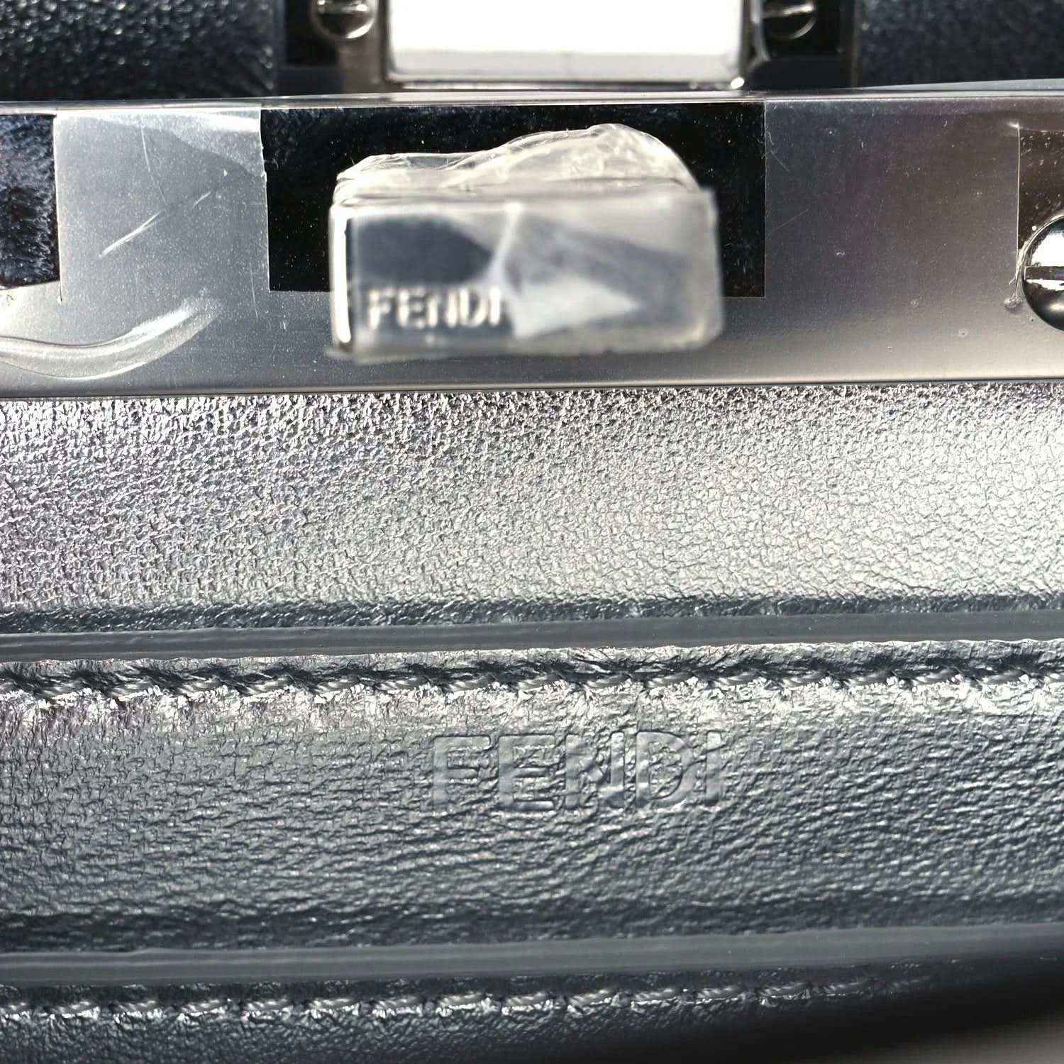 FENDI logo on interior metal plate with clear protective cover