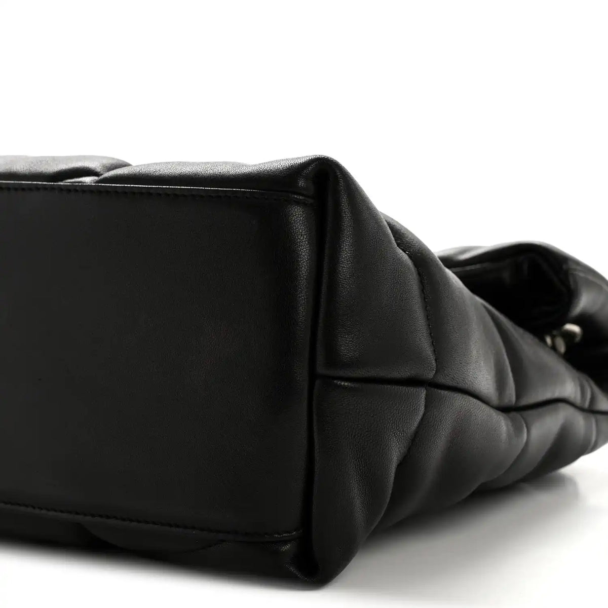 Black quilted puffer satchel end panel with stitched edge and curved side profile