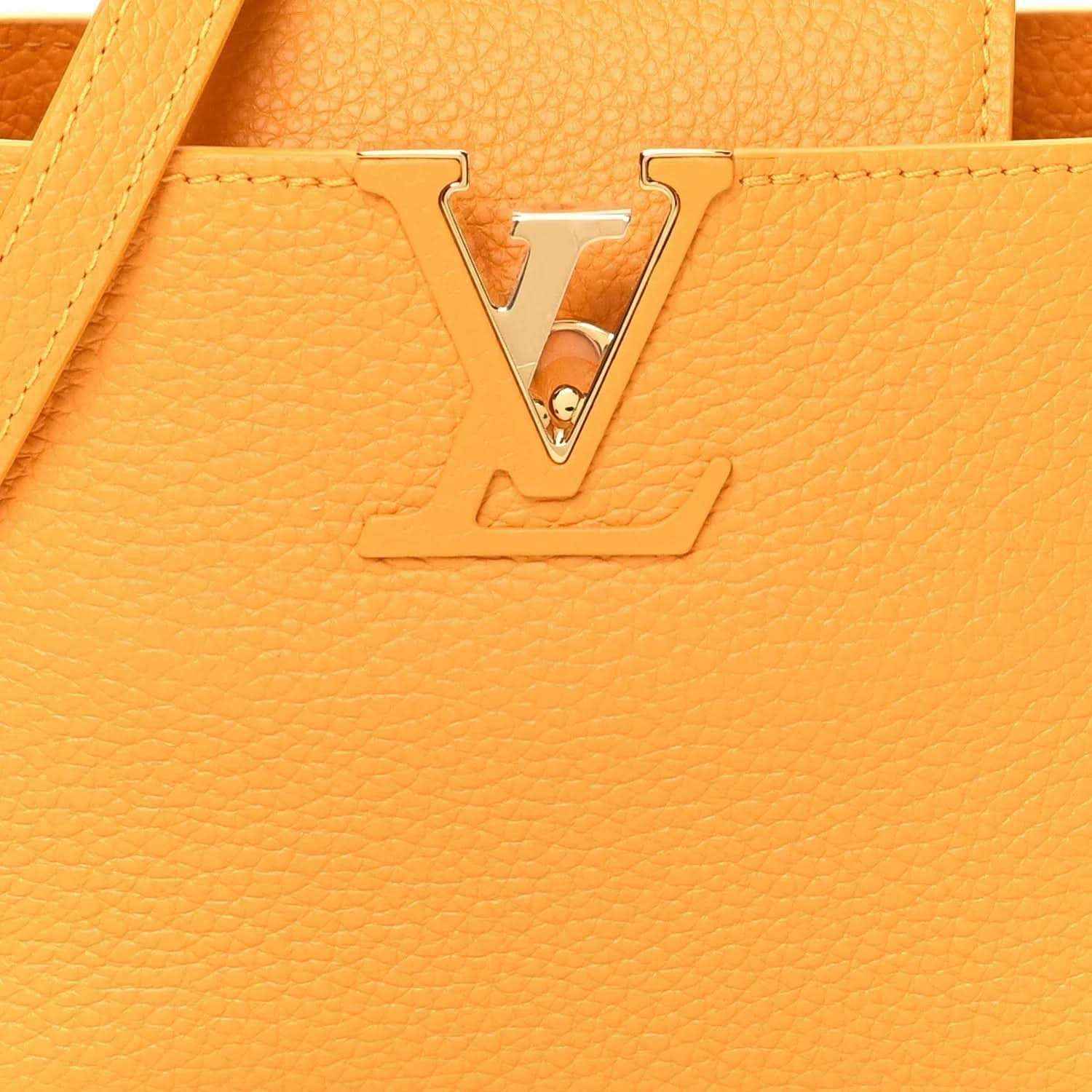 Louis Vuitton handbag in yellow textured leather with gold-tone LV lock ornament