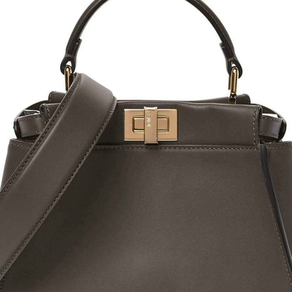 Mini Peekaboo satchel front view in dark brown leather with gold clasp.