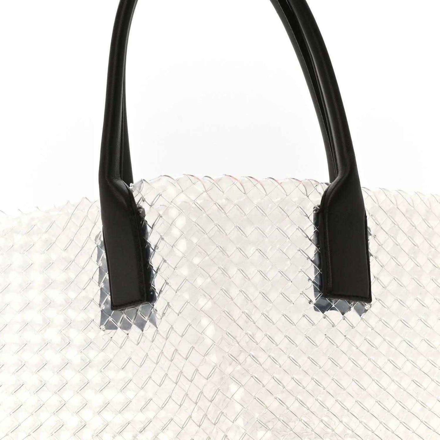Large tote bag with white woven PVC body and black leather handles