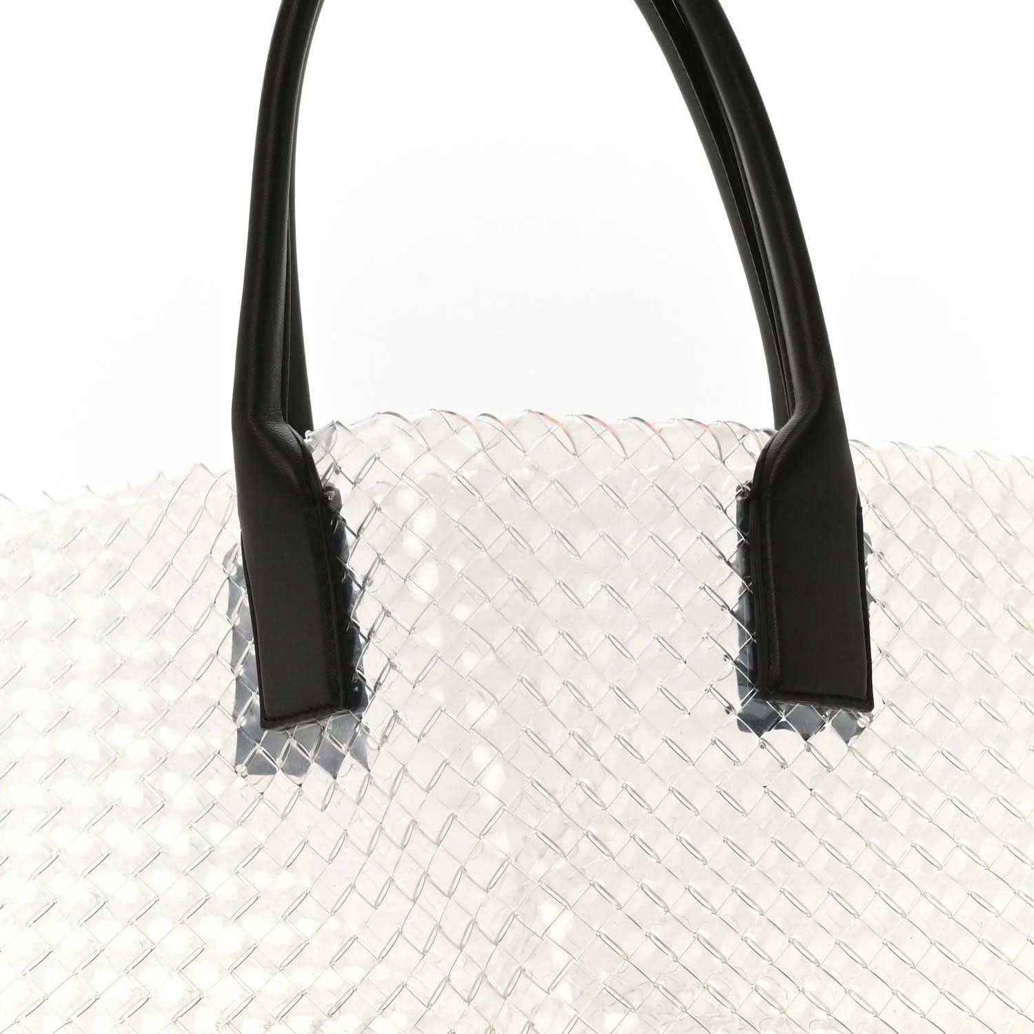 Large tote bag with white woven PVC body and black leather handles