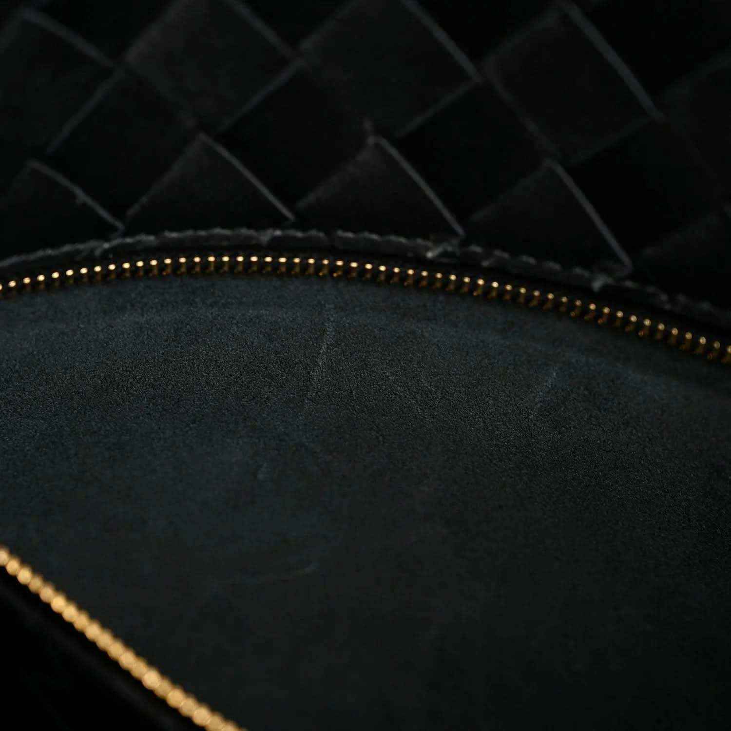Black Bottega Veneta bucket bag, gold-tone zipper top detail