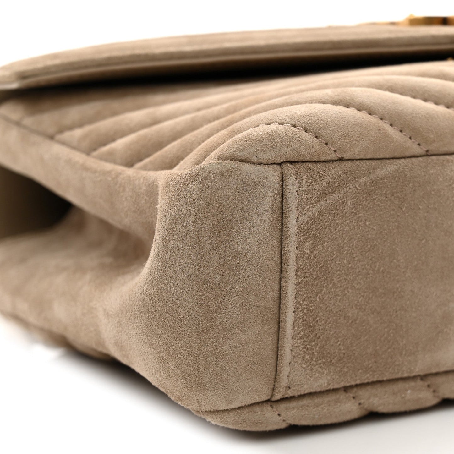 Taupe suede quilted bag close-up of side seam and structured bottom