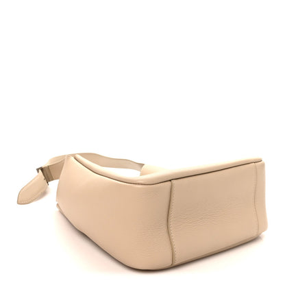 Light beige leather hobo bag with structured base and top handle
