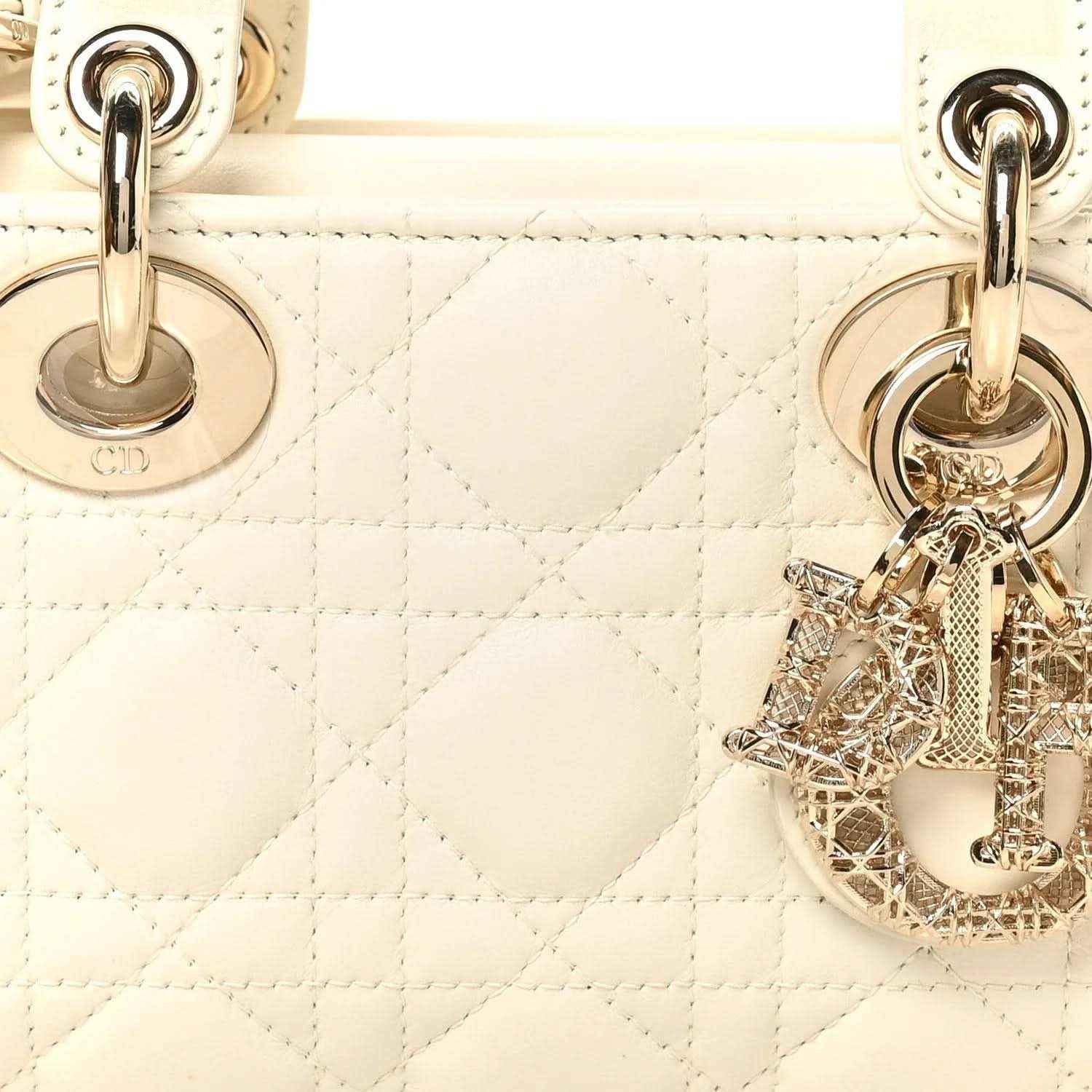 White quilted handbag with gold-tone CD ring hardware and dangling Dior charm