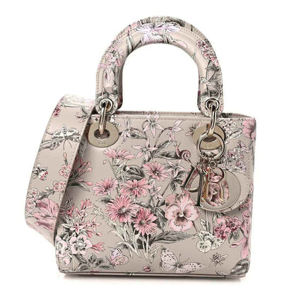 Small Lady Dior handbag with pink floral print, top handles and silver-tone hardware