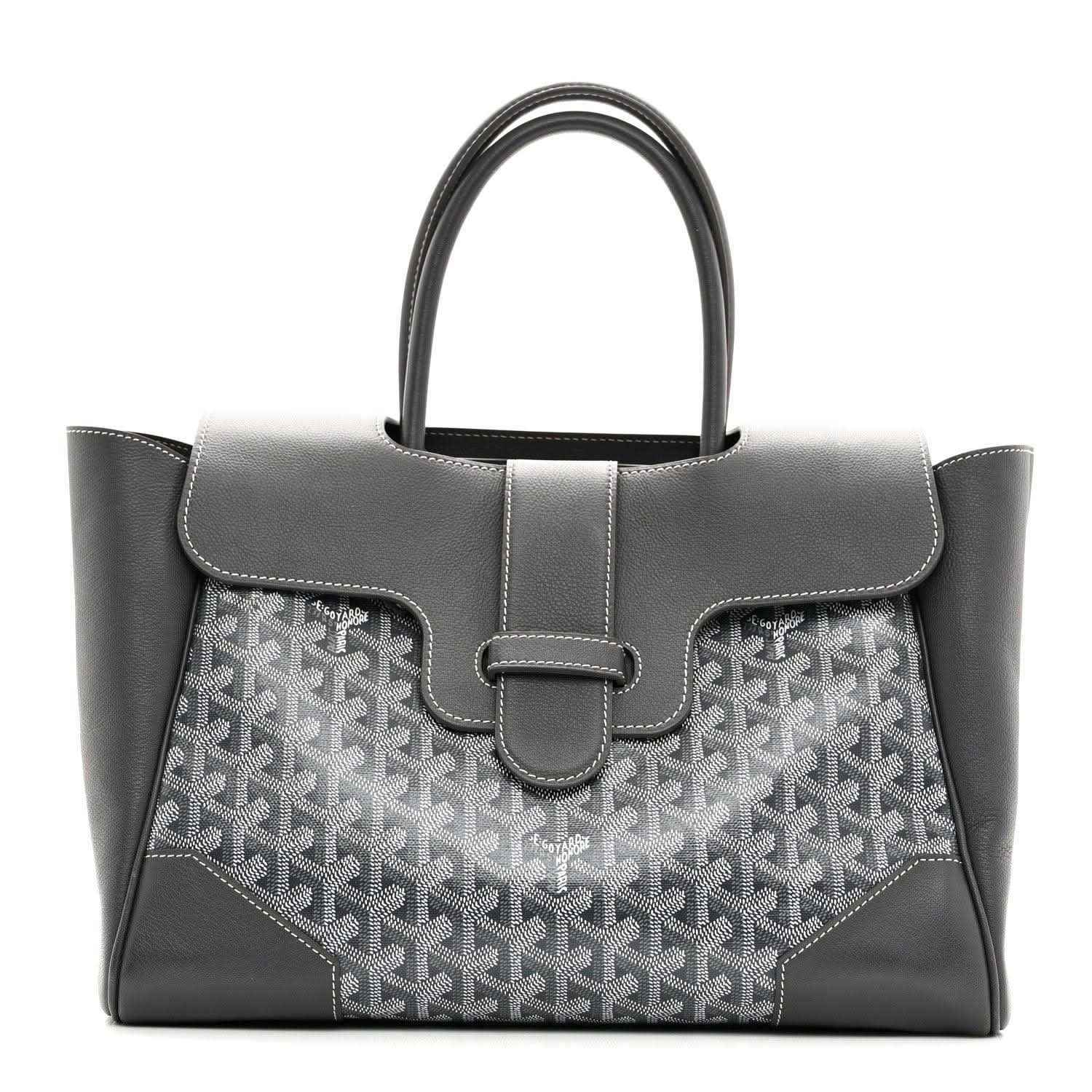 Grey Goyard tote with leather top flap, buckled center strap and patterned front