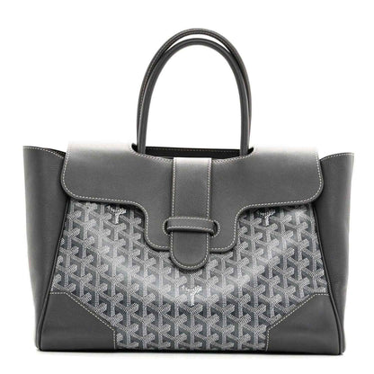 Grey Goyard tote with leather top flap, buckled center strap and patterned front