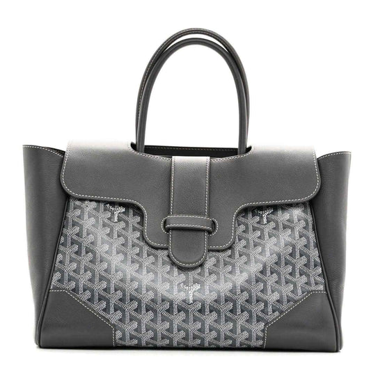 Grey Goyard tote with leather top flap, buckled center strap and patterned front