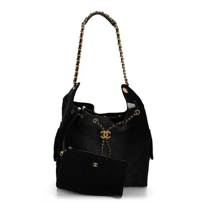 Chanel medium quilted denim shoulder bag in black with gold chain strap and CC charm