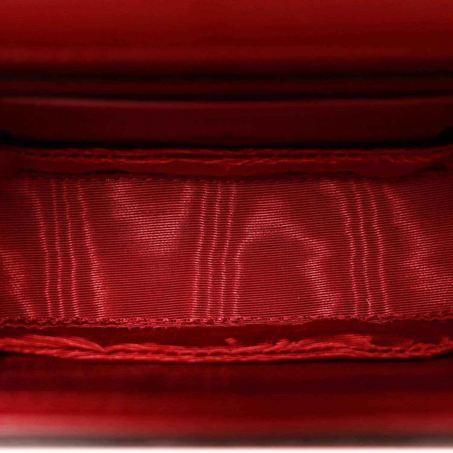 Red satin-like lining inside flap with stitched edge and seam detail.