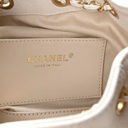 White Chanel mini handbag inside label reading CHANEL and MADE IN ITALY