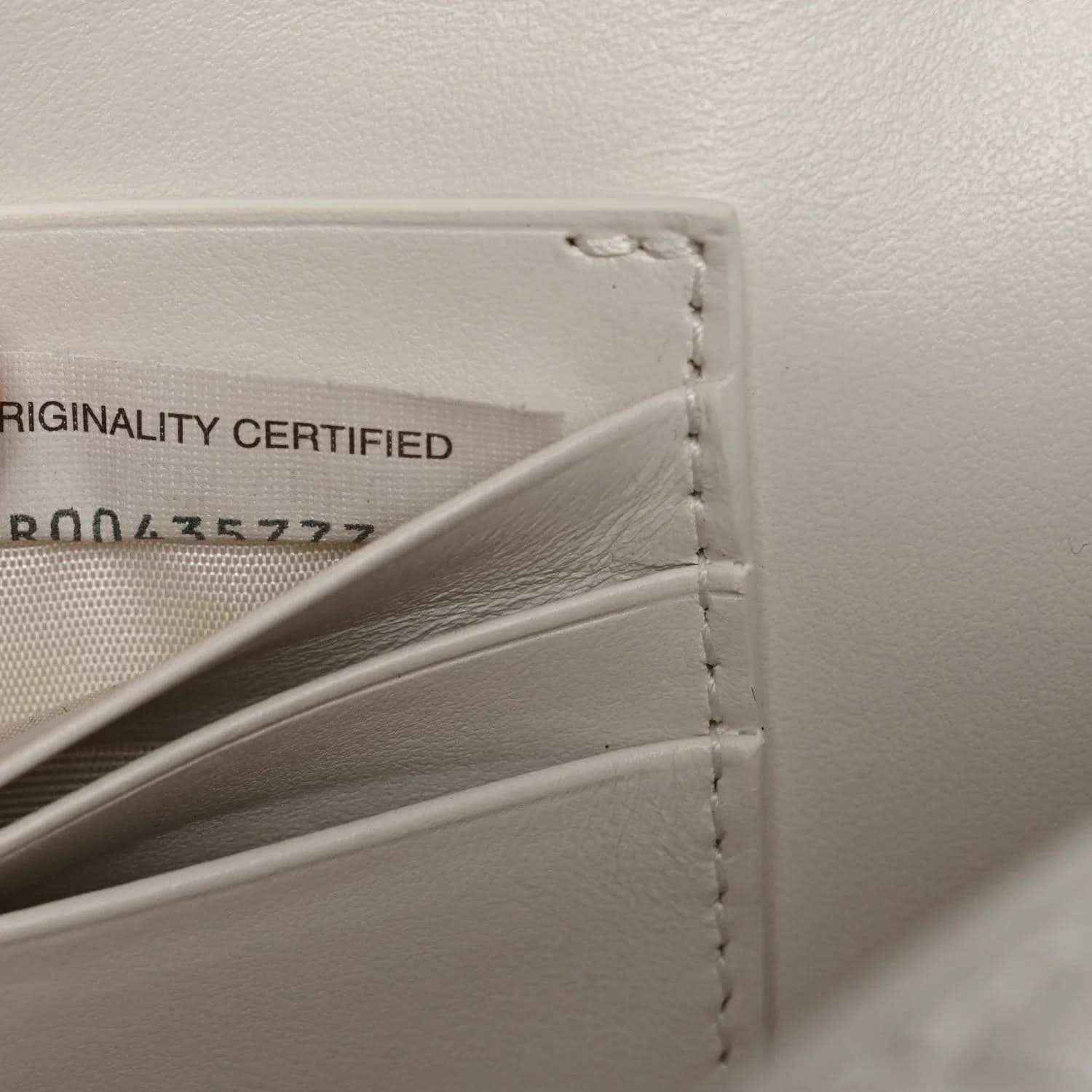 White leather clutch interior with originality label and side stitching