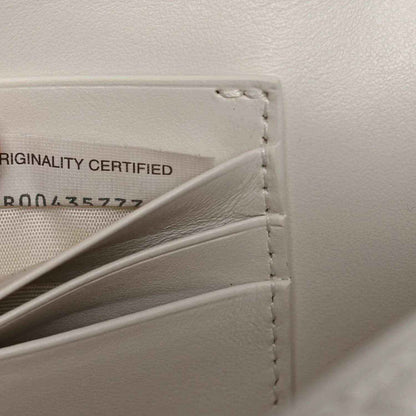 White leather clutch interior with originality label and side stitching