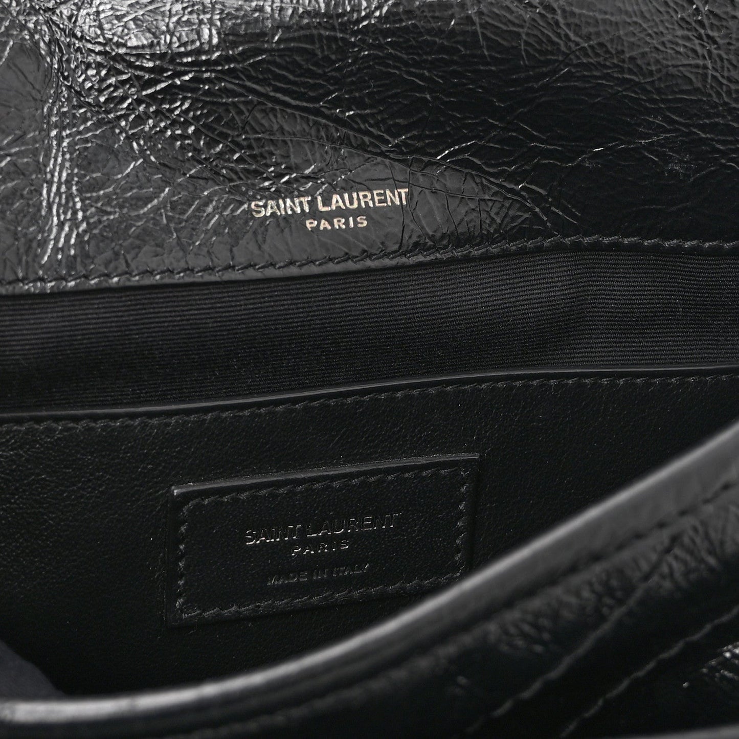 Black satchel interior with Saint Laurent Paris stamp on leather