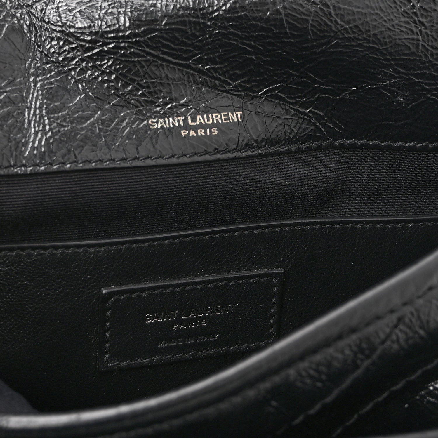 Black satchel interior with Saint Laurent Paris stamp on leather