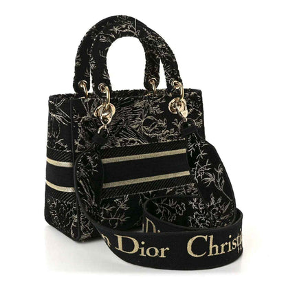 Black embroidered handbag with gold toile de jouy motif, top handles and front band