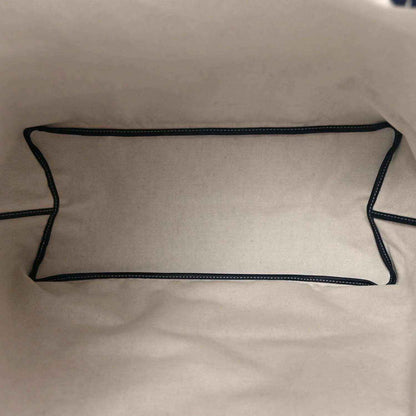 Navy-lined interior pocket with stitched edges inside the tote bag.