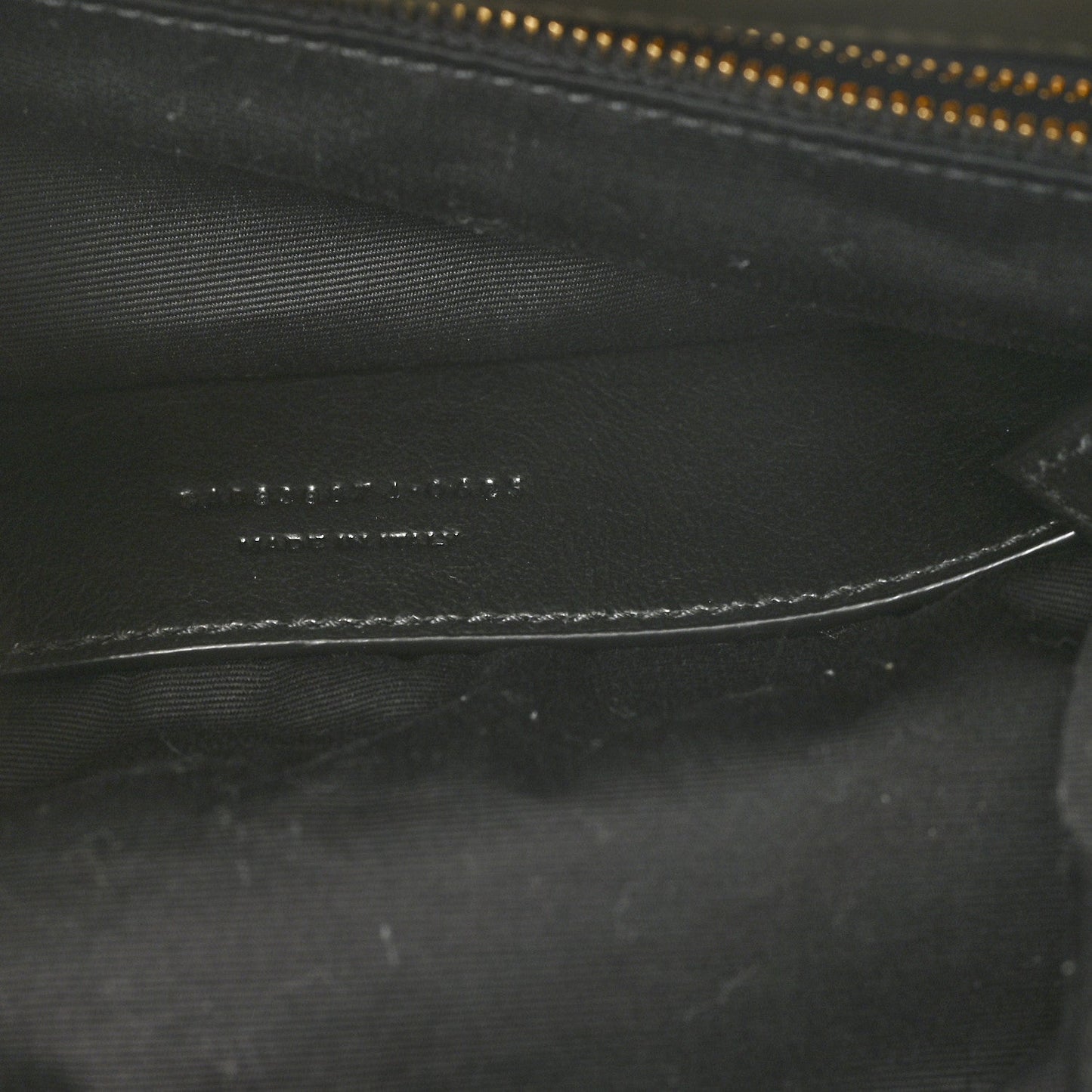 Black leather interior detail with zipper track and fine stitching lines