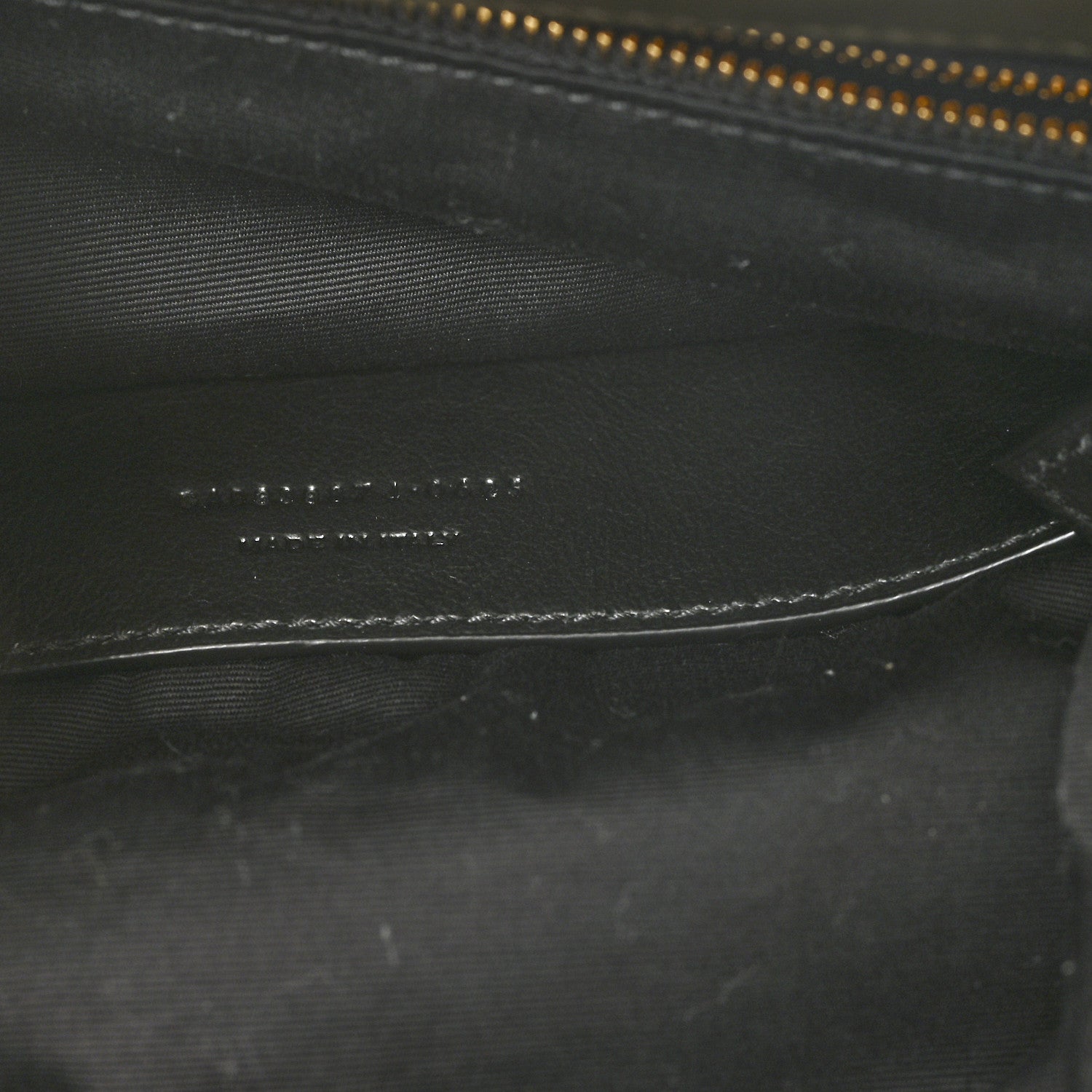 Black leather interior detail with zipper track and fine stitching lines