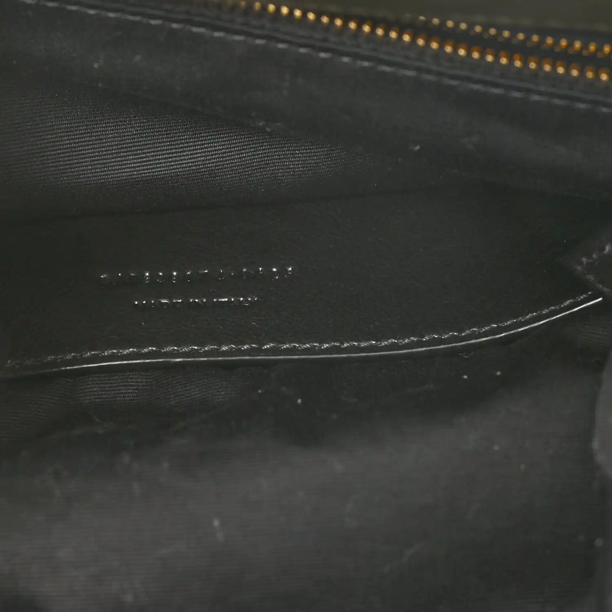 Black leather interior detail with zipper track and fine stitching lines