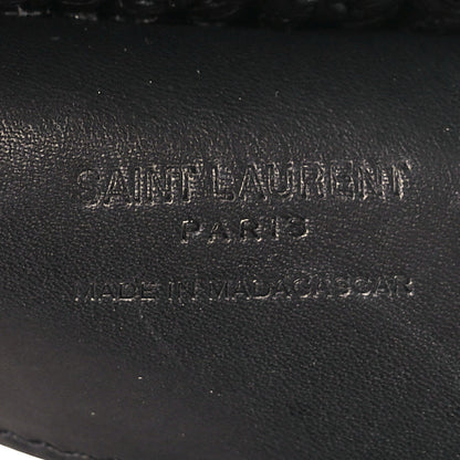 Black leather interior label with stamped text on shoulder bag