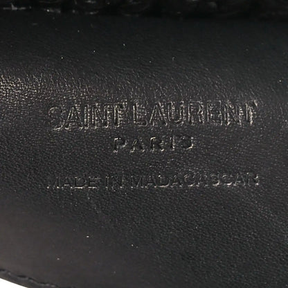 Black leather interior label with stamped text on shoulder bag