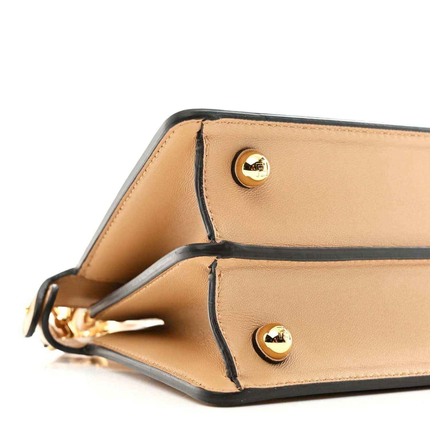 Small satchel side view with two gold-tone snap buttons and dark edge trim