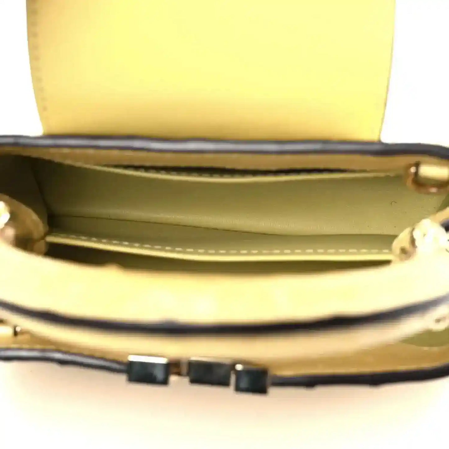 Yellow mini bag interior with leather trim and structured top opening