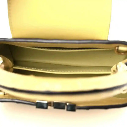 Yellow mini bag interior with leather trim and structured top opening
