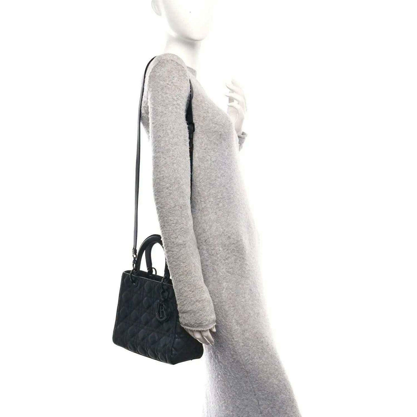 Black quilted Lady Dior bag with top handle and shoulder strap, side view