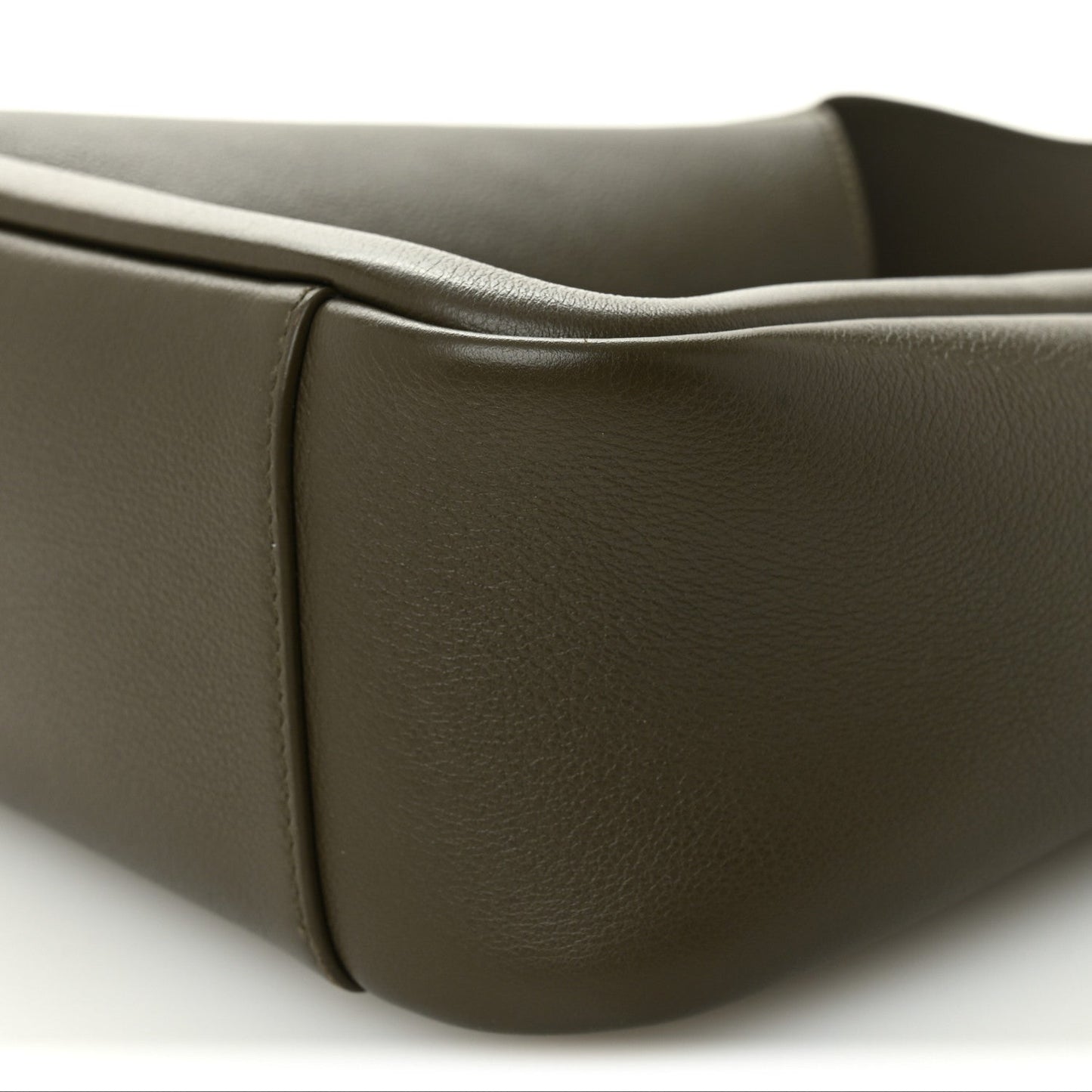 Calfskin hobo bag corner close-up showing smooth leather and rounded edge.