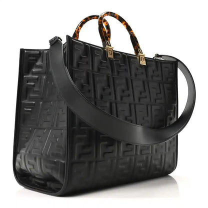 Black embossed leather tote bag with FF pattern, top handles, and wide shoulder strap