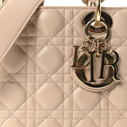 Beige quilted handbag with CD charm hardware and gold ring attachment