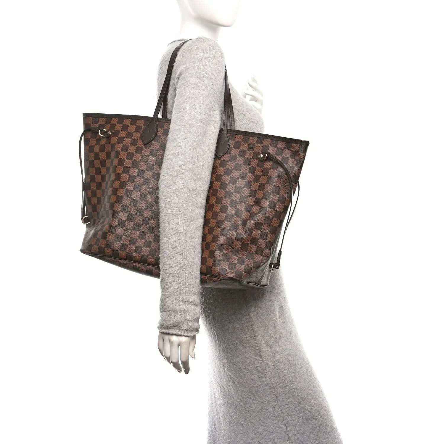 Damier Ebene tote bag shown from the side with dark leather trim and handles