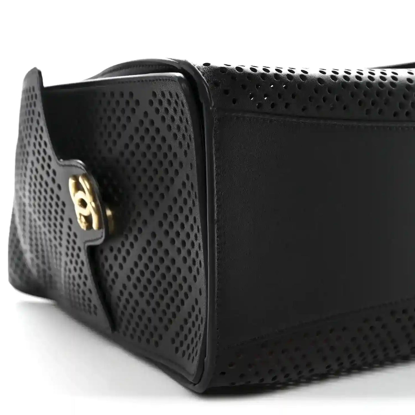 Chanel small handbag in black perforated calfskin with gold logo plaque, profile