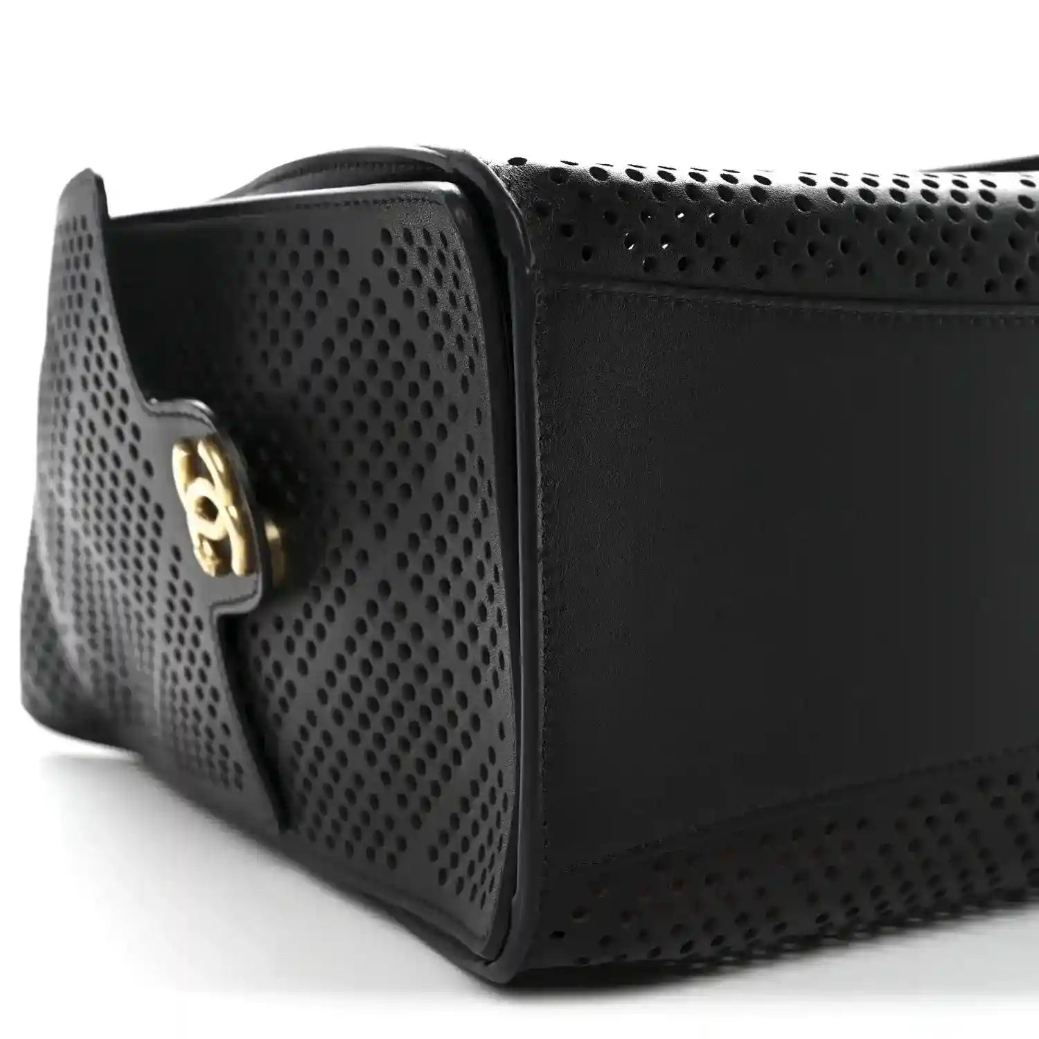 Chanel small handbag in black perforated calfskin with gold logo plaque, profile