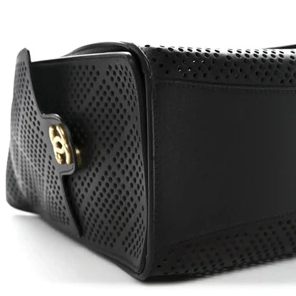 Chanel small handbag in black perforated calfskin with gold logo plaque, profile