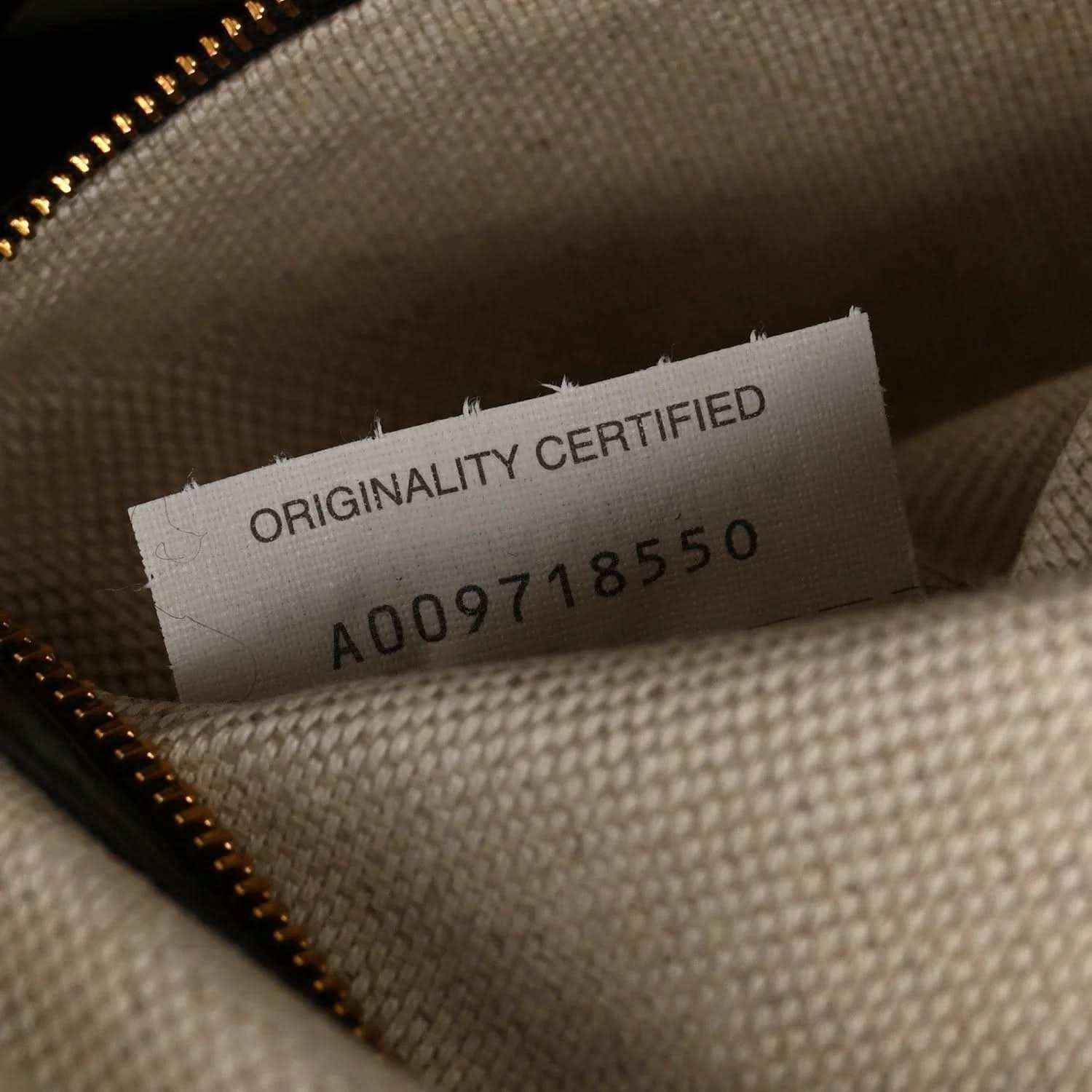 Weekender bag interior tag reading 'ORIGINALITY CERTIFIED' with code