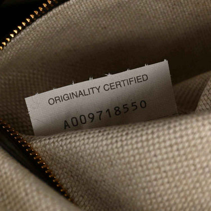 Weekender bag interior tag reading 'ORIGINALITY CERTIFIED' with code