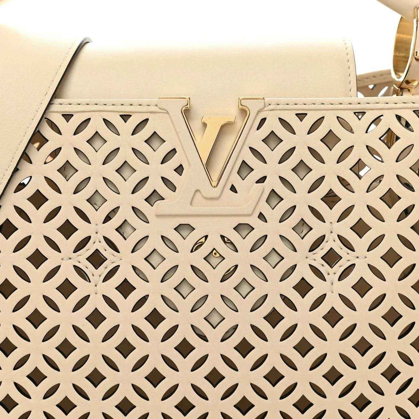 Louis Vuitton handbag front panel close-up with V detail and cut-out lattice pattern