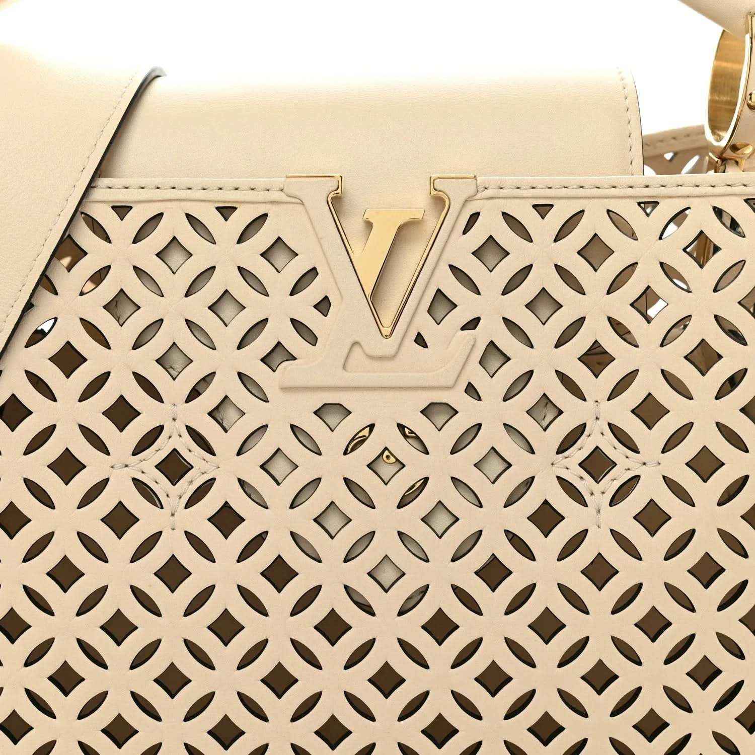 Louis Vuitton handbag front panel close-up with V detail and cut-out lattice pattern