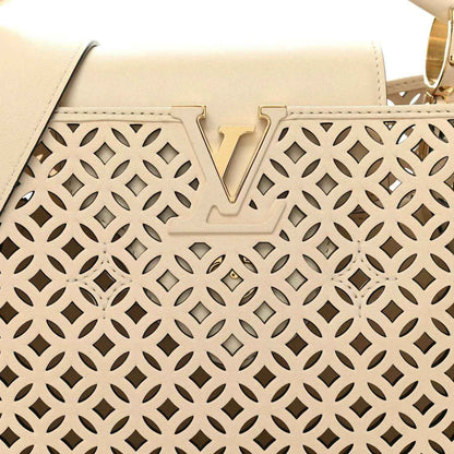 Louis Vuitton handbag front panel close-up with V detail and cut-out lattice pattern